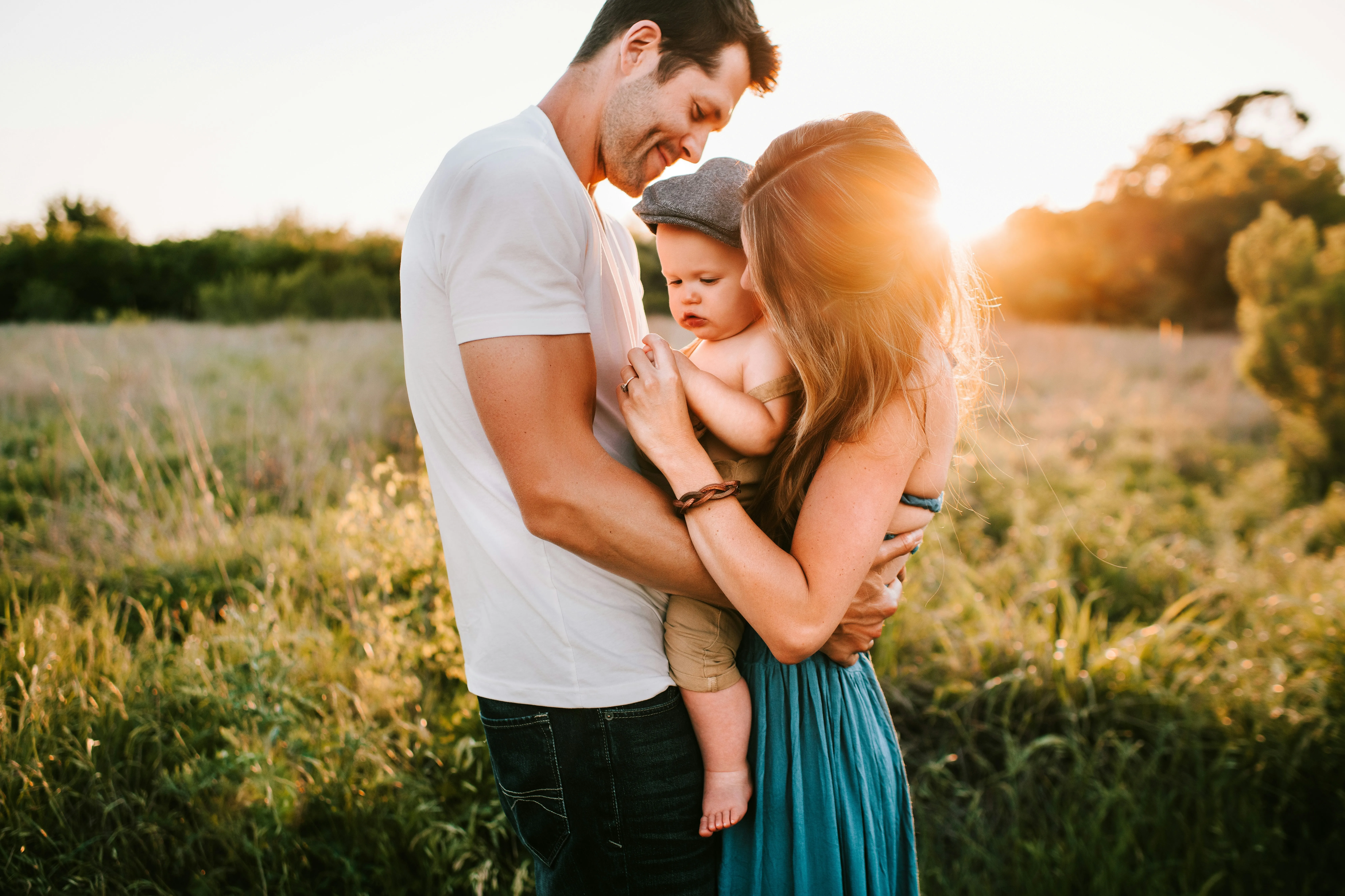 family photo on green grass during golden hour by Jessica Rockowitz courtesy of Unsplash.